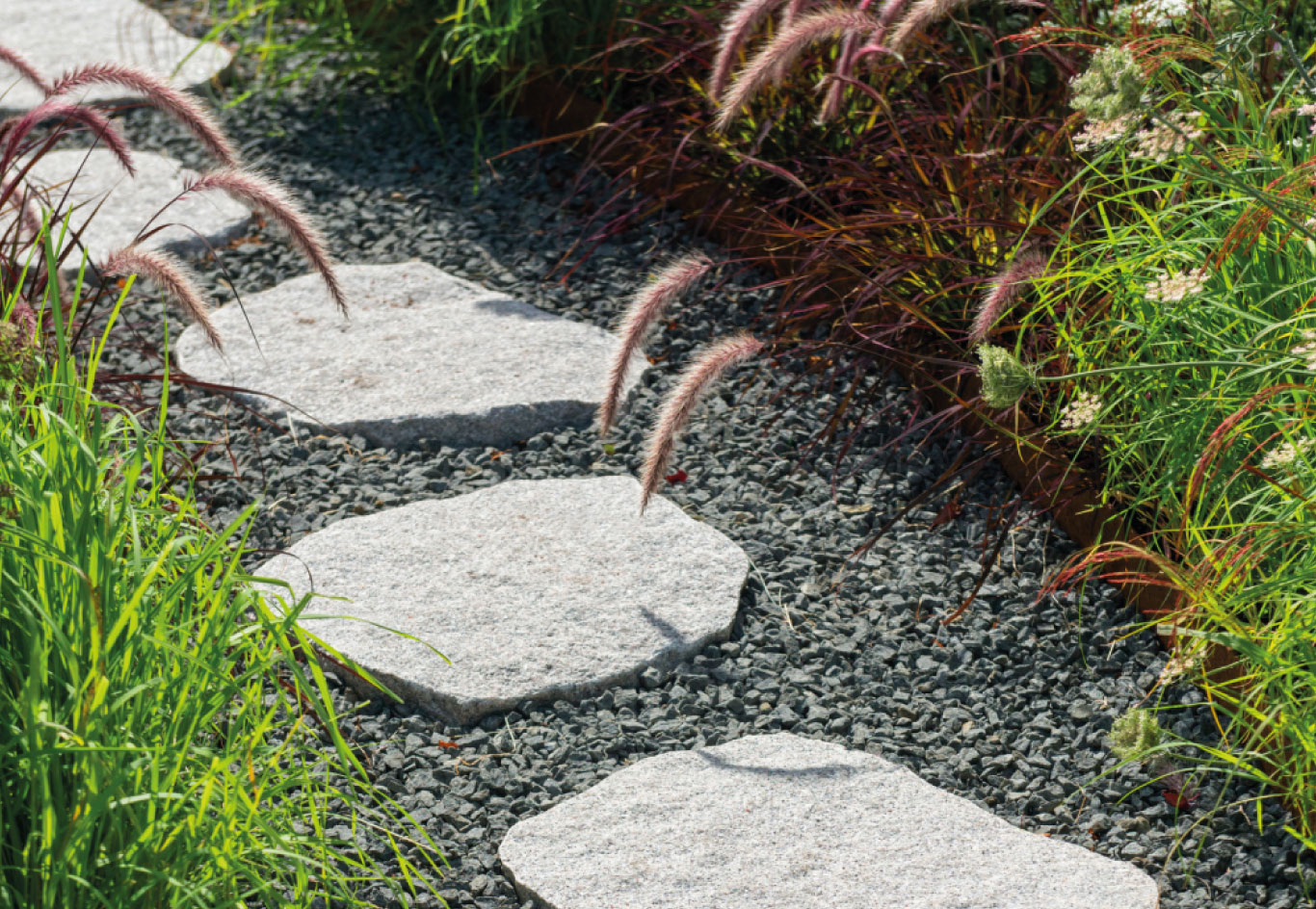 Natural stone garden path with ornamental grasses