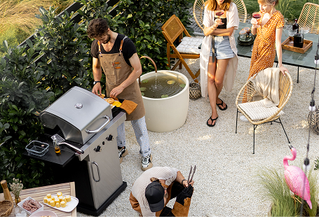 Backyard barbecue near outdoor kitchen setup