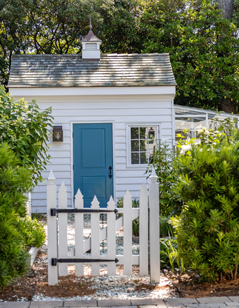 White garden shed with blue door